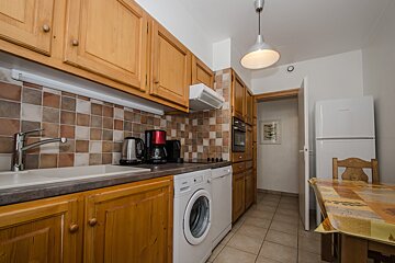 A kitchen with a washing machine and a dishwasher