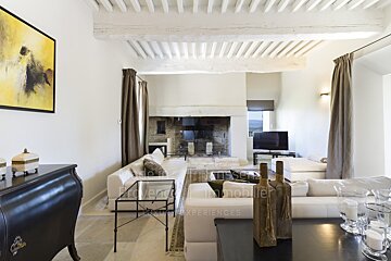 A living room with a fireplace and a dresser that says provence immobilier
