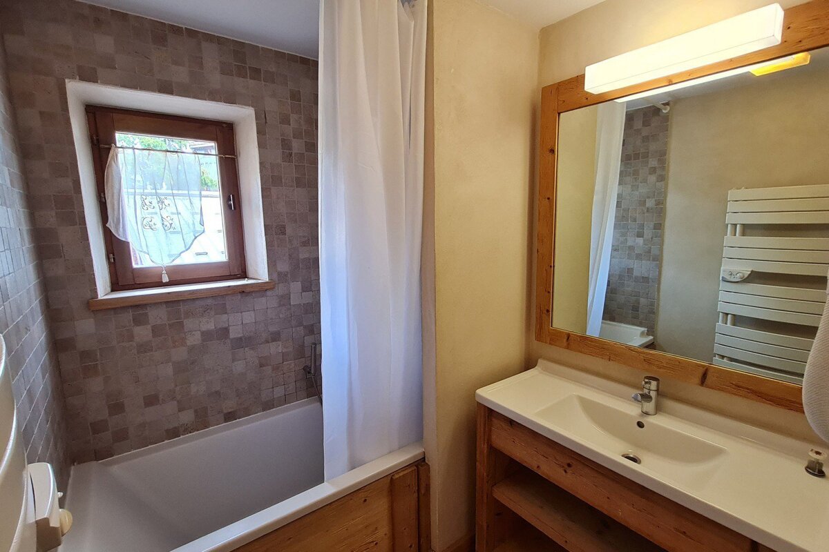 A bathroom with a sink and a window