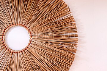 A picture of a straw wreath with the word home studio written on the bottom