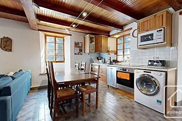 A kitchen with a washing machine and a microwave