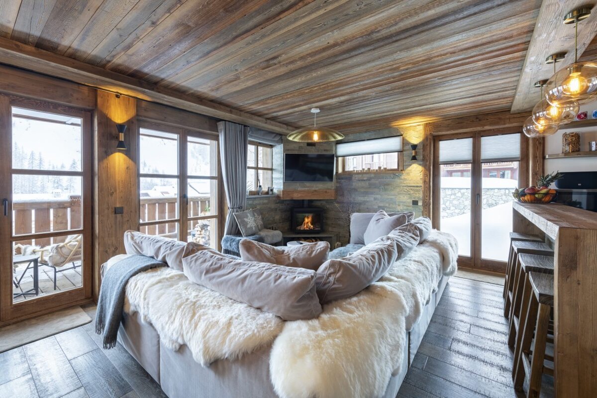 A living room with a large couch and a fireplace