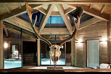 A statue of a deer skull in a wooden building