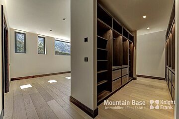 A walk in closet with a sign that says mountain base