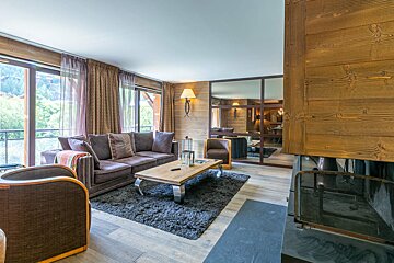 A living room with a couch and chairs and a fireplace