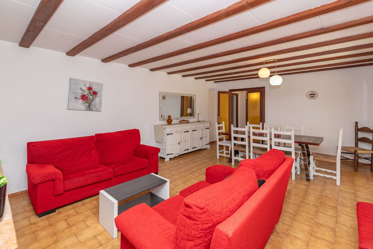 A living room with two red couches and a table