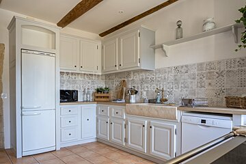 A kitchen with white cabinets and a bosch dishwasher