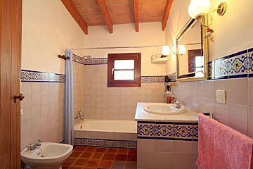 A bathroom with a sink a bathtub and a mirror