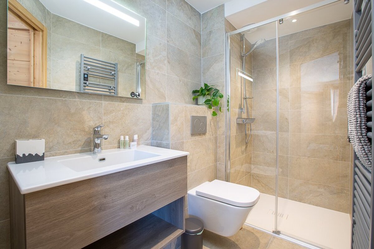 A bathroom with a toilet a sink and a mirror
