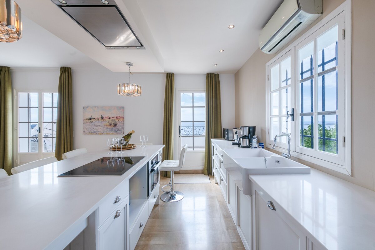 A kitchen with a stove top oven and a sink