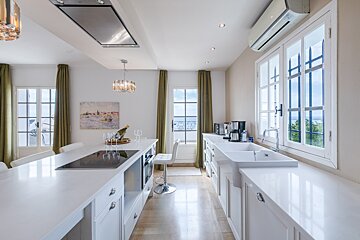 A kitchen with a stove top oven and a sink