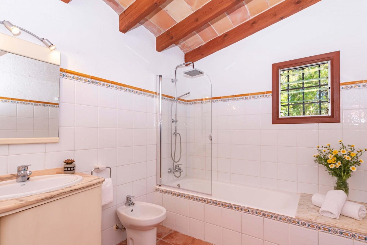 A bathroom with a sink a bidet and a bathtub