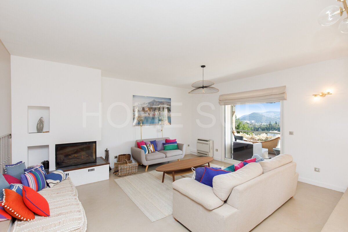 A living room with a couch and a fireplace and a sign that says homes