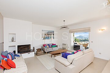 A living room with a couch and a fireplace and a sign that says homes