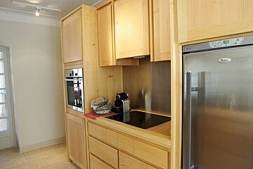 A kitchen with a stainless steel refrigerator that says whirlpool on it
