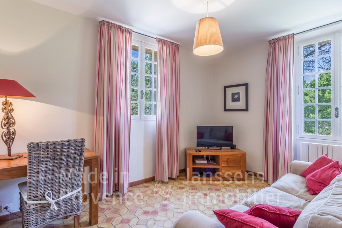 A living room with a couch and a desk with the words made in provence written on the wall