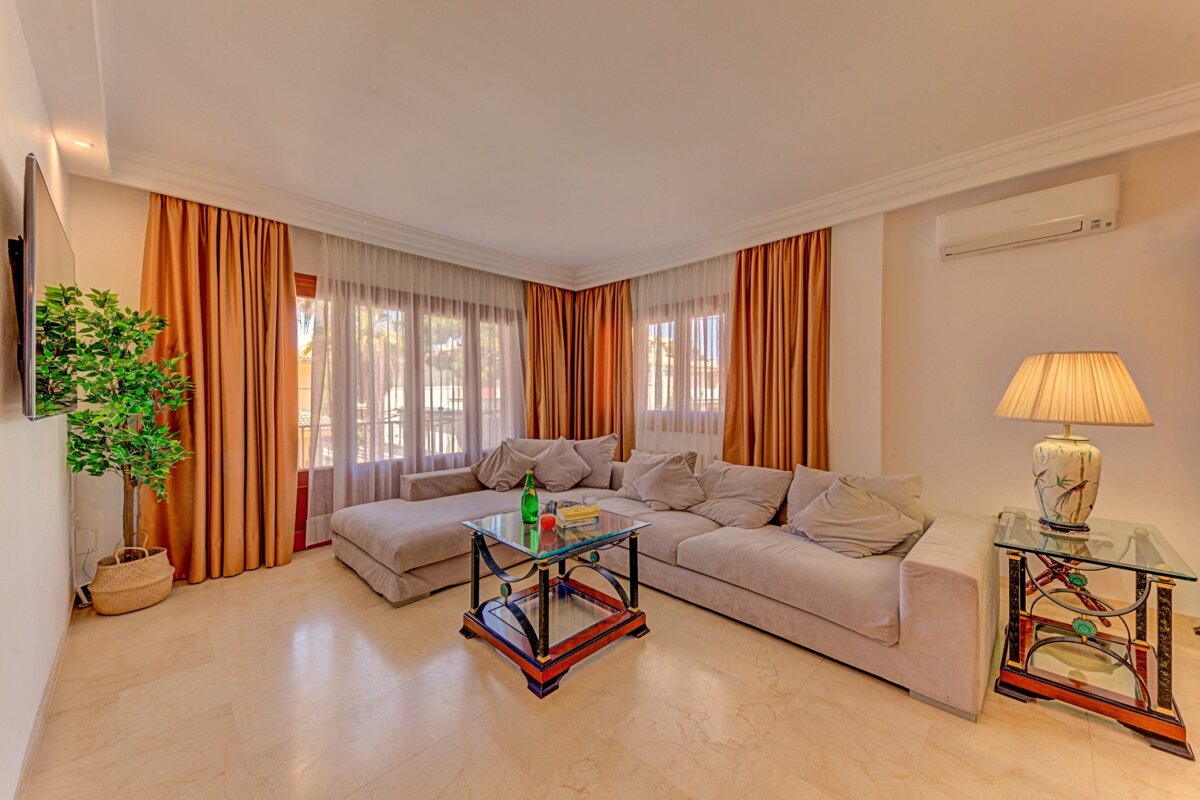 A living room with a couch and a lamp