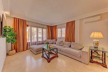 A living room with a couch and a lamp