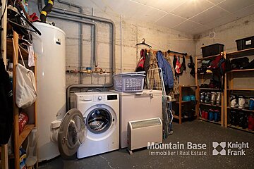 A washer and dryer are in a laundry room sponsored by mountain base immobilier real estate