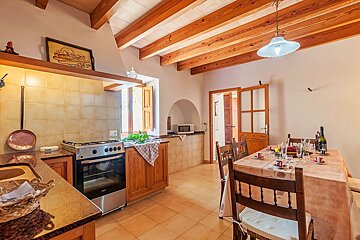 A kitchen with a table and chairs and a stove