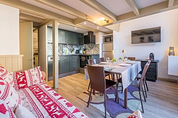 A living room with a couch and a dining table
