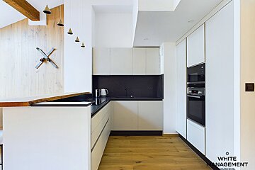 A kitchen with a clock on the wall that says white management