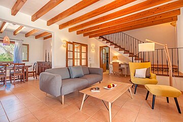 A living room with a couch and a yellow chair