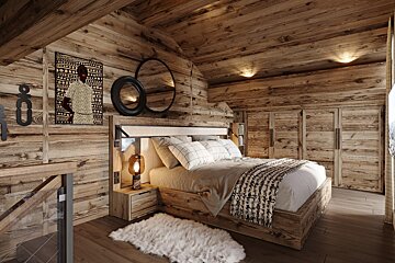 A bedroom with wooden walls and a bed