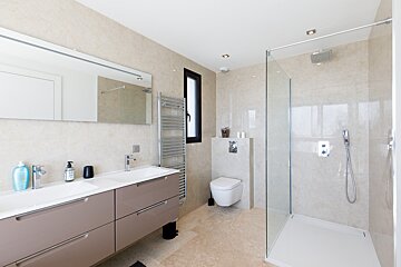 A bathroom with a walk in shower and a toilet