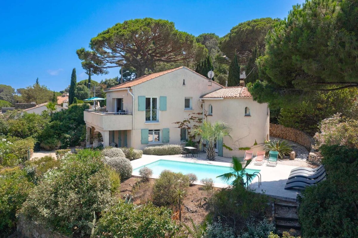 A large house with a swimming pool in front of it