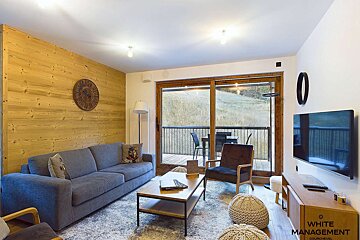 A living room with a couch and chairs and a sign that says rental designer