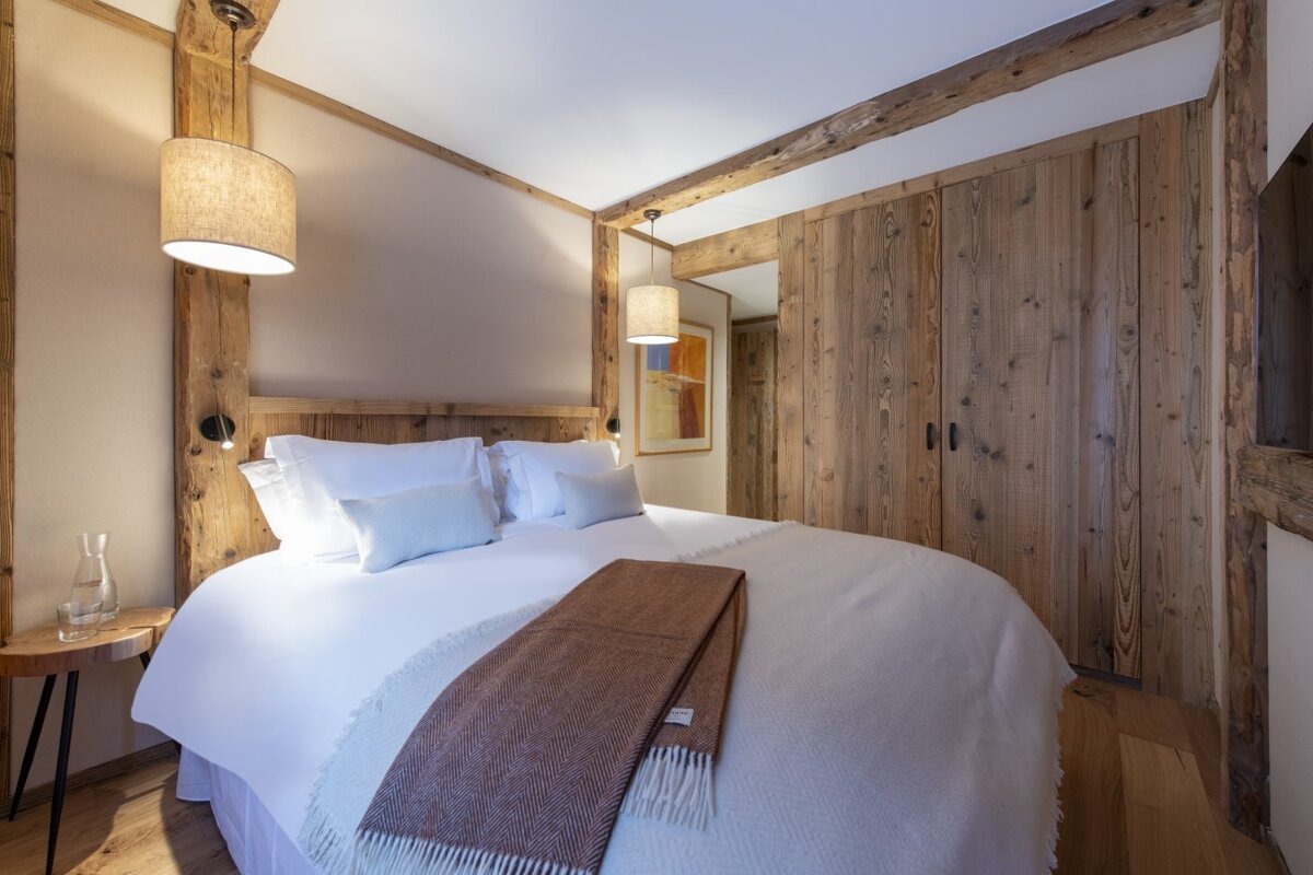 A bed with a brown blanket on it in a bedroom