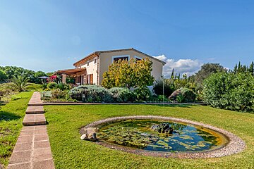 A house with a pond in front of it
