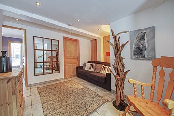 A living room with a couch and a rocking chair
