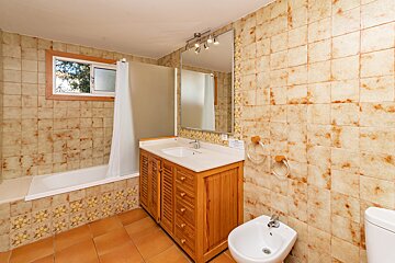 A bathroom with a sink a toilet and a bathtub