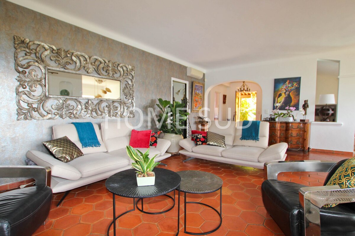 A living room with a couch and two tables and the word home on the wall
