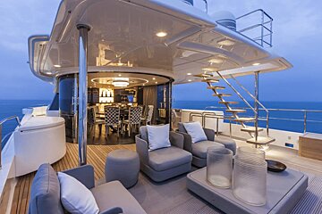 A large yacht has a staircase leading up to the deck