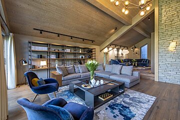 A living room with a couch and chairs and a coffee table