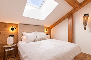 A bedroom with a couch and a bed in it