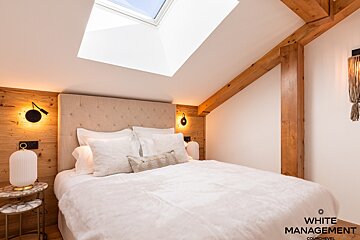 A bedroom with a couch and a bed in it