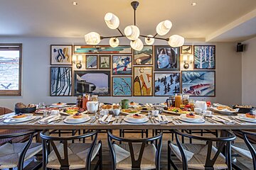 A large dining room table with plates of food on it