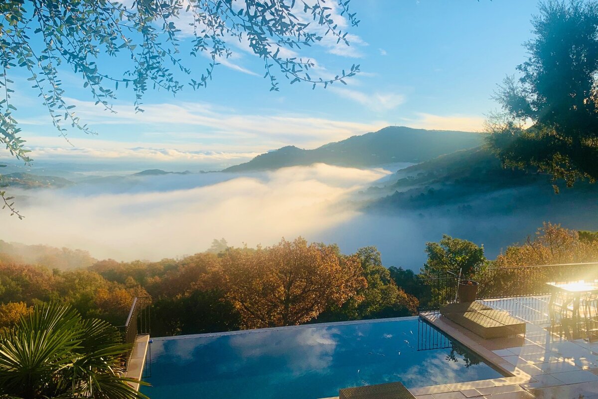 A swimming pool with a view of mountains and clouds