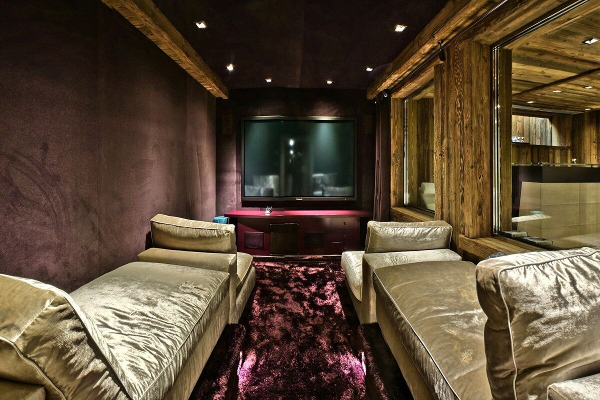 A room with purple walls and a flat screen tv