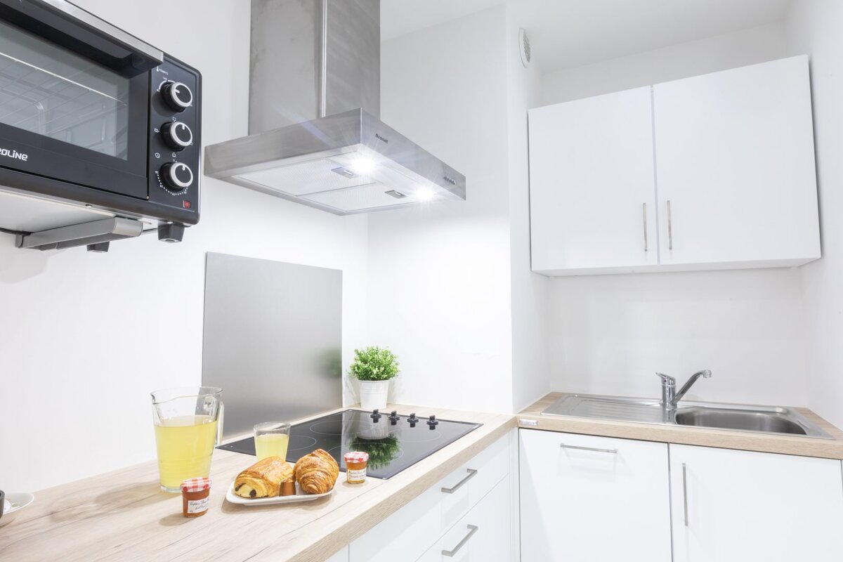 A kitchen with a duke oven on top of it