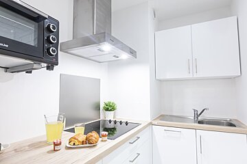 A kitchen with a duke oven on top of it