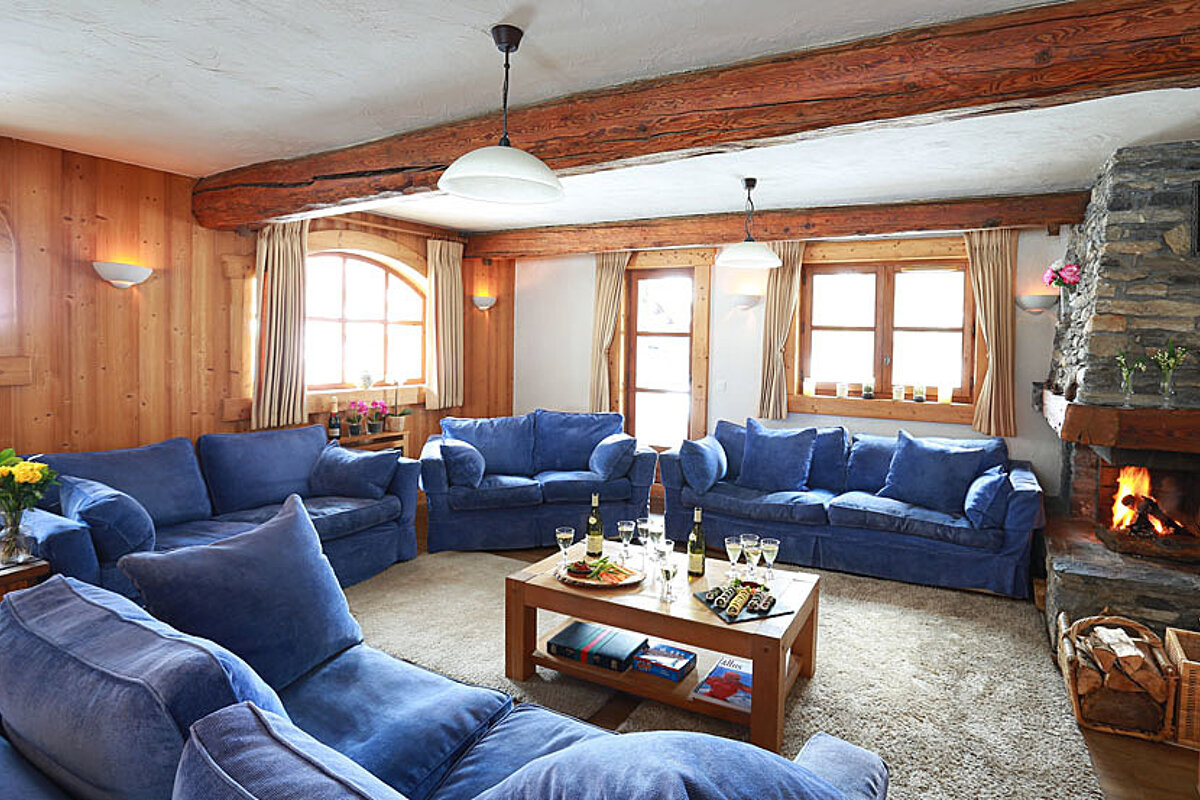 A living room with blue furniture and a fireplace