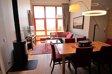 A living room with a dining table and chairs