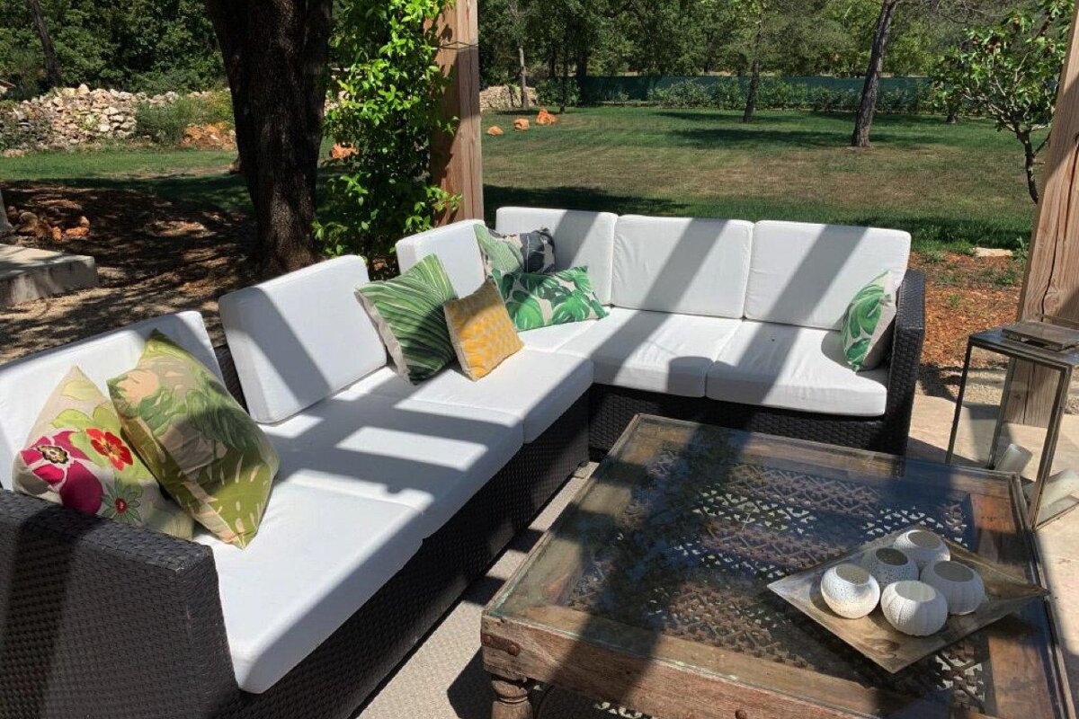 A patio area with a couch and a coffee table