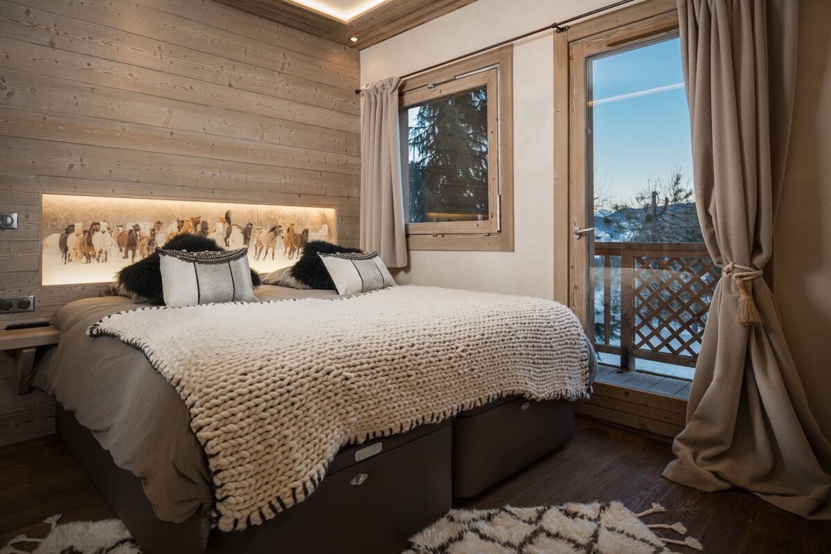 A bedroom with a large bed and a window