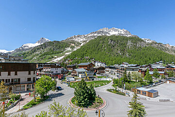 A small town with a mountain in the background